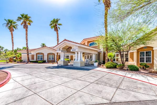 Entrance of Spring Valley Memory Care with palm trees