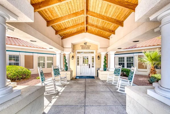 Entrance of a senior care facility with rocking chairs