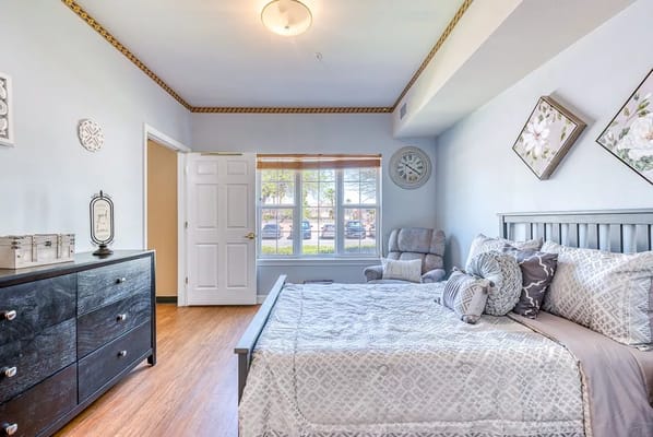 Bright and cozy resident room with a bed and window