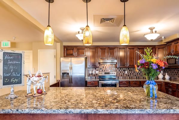 Interior kitchen area with granite countertops and flowers