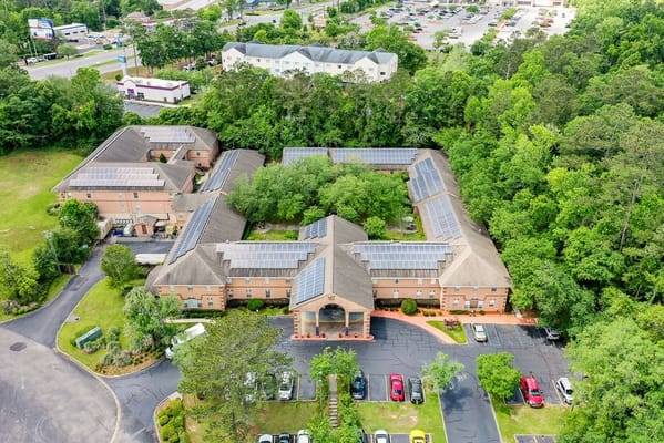 Aerial view of a senior living facility surrounded by trees