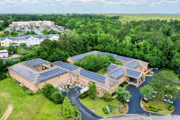 Aerial view of the Woodmont Senior Living facility surrounded by trees