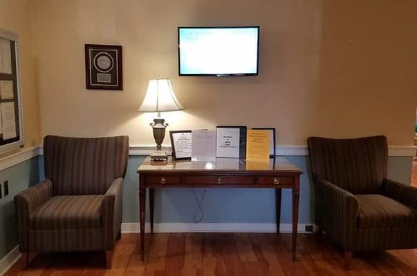 Seating area with lamps and informational displays in a common area