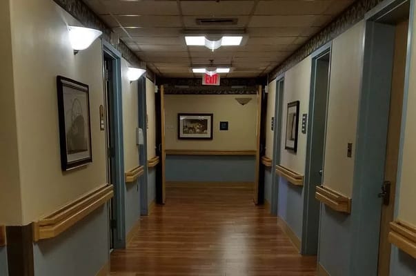 Long hallway in a senior care facility with artwork