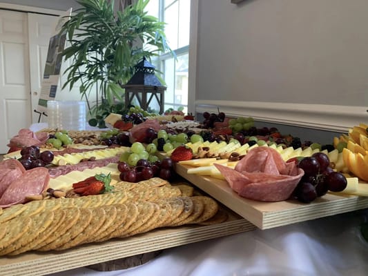 A beautifully arranged charcuterie board with fruits and cheeses