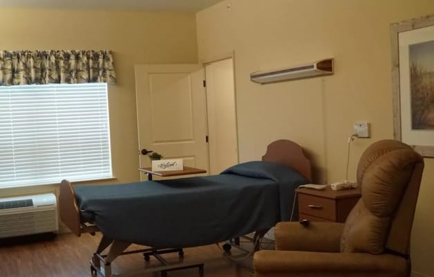 Private resident room with bed and seating area