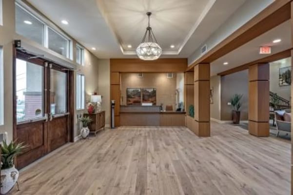 Bright lobby area with wooden floors and reception