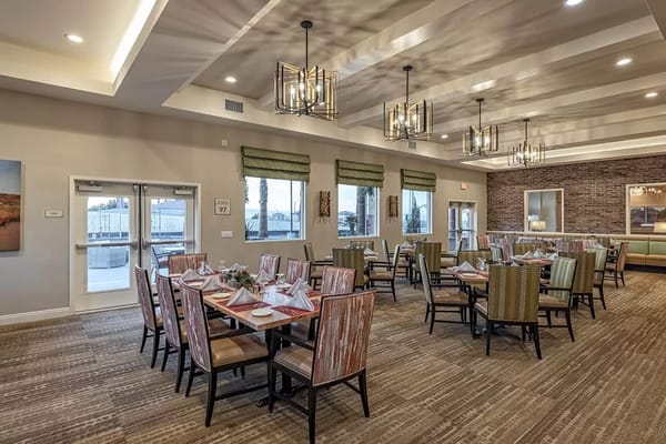 Bright dining room with tables set for meals