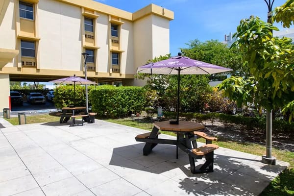Outdoor seating area with umbrellas near the building