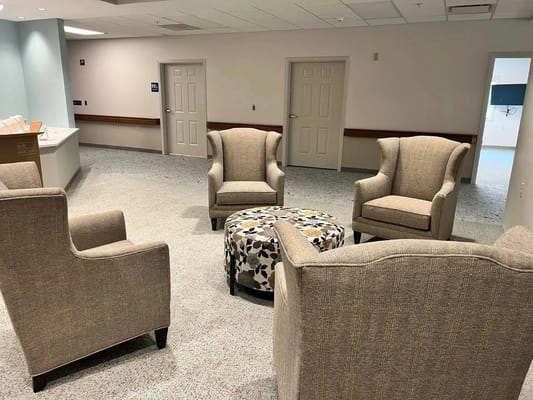 Lounge area with two armchairs and a patterned ottoman