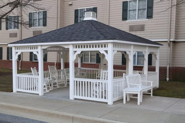 Outdoor gazebo with rocking chairs.