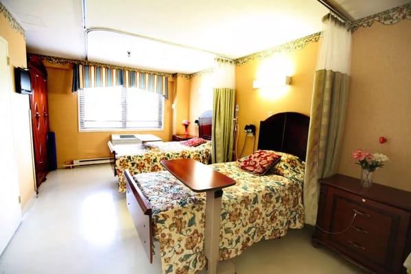 A well-appointed bedroom with two beds in Park Gardens Rehabilitation Center.