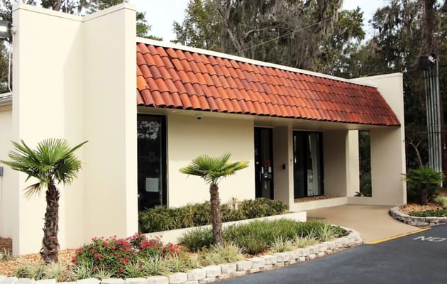 Exterior view of a building entrance with landscaping