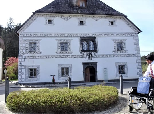 Exterior view of a retirement facility with a wheelchair user