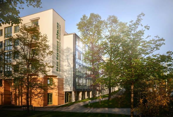 Exterior view of Am Kurpark Retirement Oberlaa surrounded by greenery