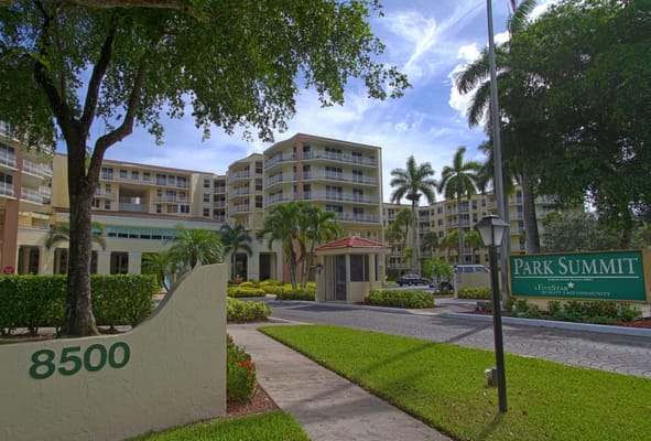 Exterior view of Park Summit senior living facility with lush landscaping.
