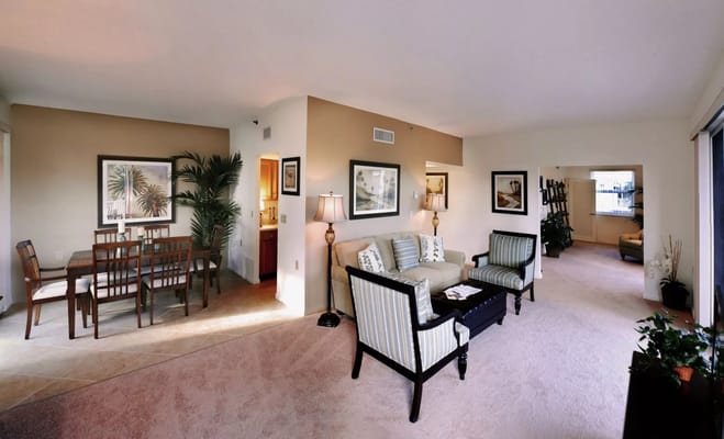 Spacious living room with dining area and kitchen access.