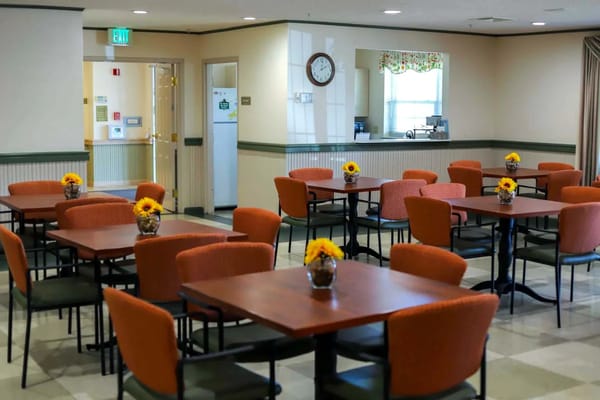 Interior view of the dining room with tables and sunflower centerpieces.