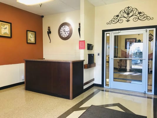 Reception area with desk and clock