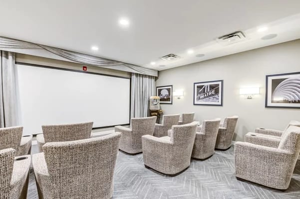 Cozy theater room with plush seating and a large screen