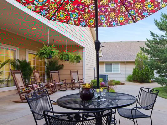 Outdoor patio with colorful umbrella and seating