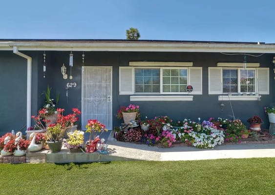 Building exterior with colorful flower beds
