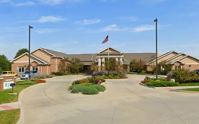 Exterior view of a senior living facility with landscaping