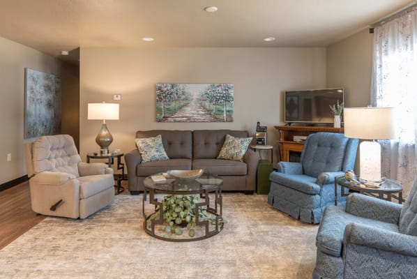 A cozy living room with comfortable seating and warm lighting.