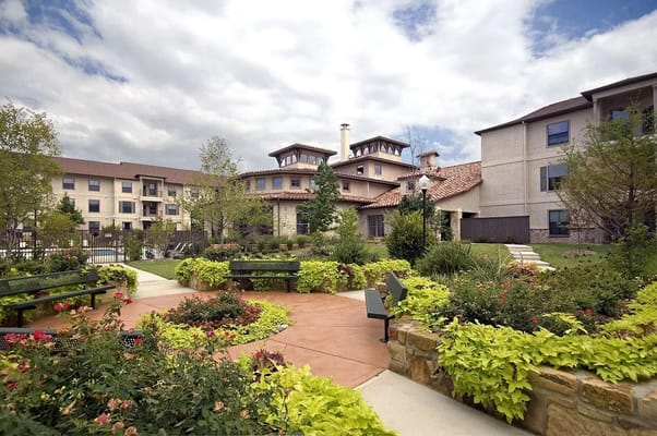 Lush garden area with benches and flowering plants at Parkview.