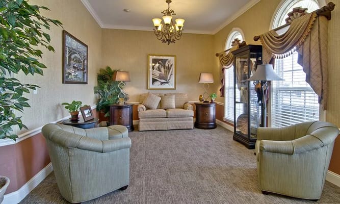 Cozy lounge with comfortable seating and decorative plants.