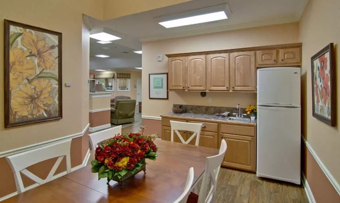 Interior view of a kitchen and dining area with flowers