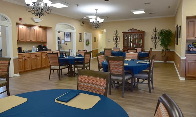 Dining room with blue tablecloths and wooden furniture