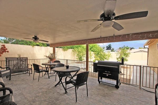 Covered outdoor patio area with seating