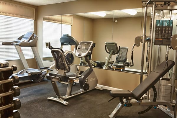 Fitness center equipment including a stationary bike and elliptical machine.