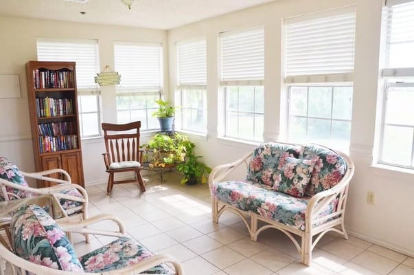 Bright common area with floral seating and windows