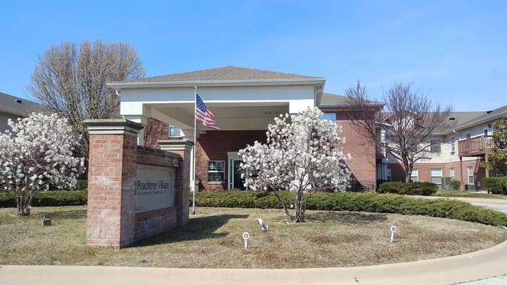 Exterior view of Peachtree Village with blooming trees