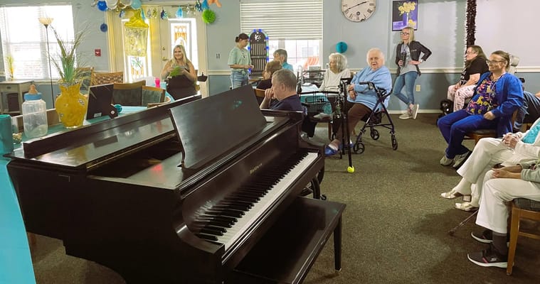 Residents enjoying a musical performance in a common area