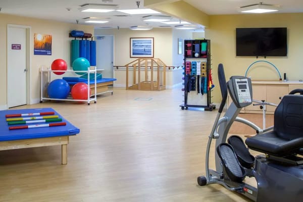 Rehabilitation gym with exercise equipment and therapy space
