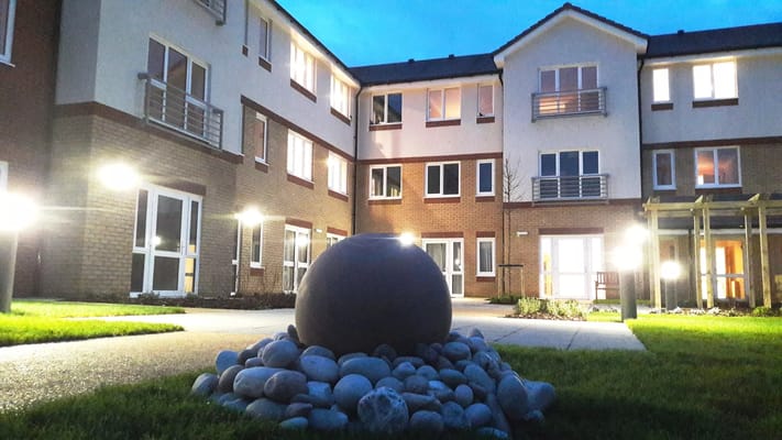 Outdoor space featuring landscaping and building facade