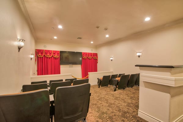 Cozy media room with seating and a large screen