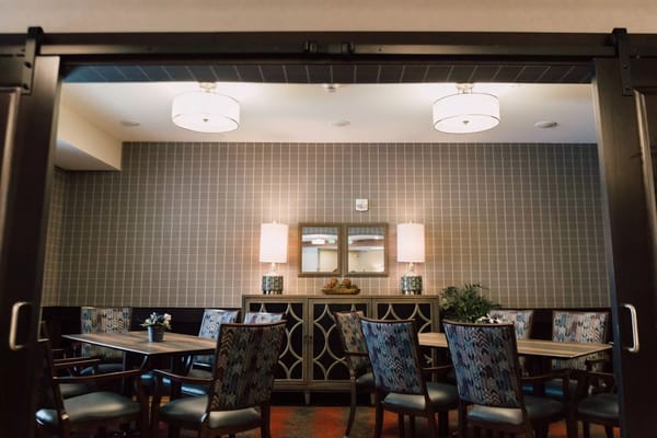 Cozy common area with dining tables and decorative lighting