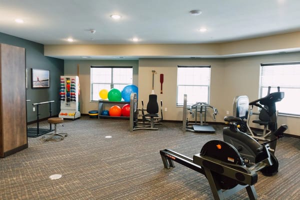 Interior view of a fitness room with exercise equipment.