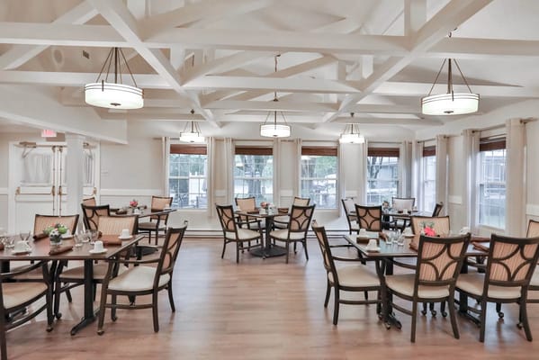 Elegant dining room with wooden tables and natural light