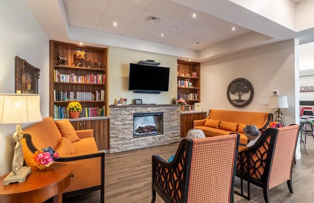 Common area with seating, bookshelves, and a fireplace