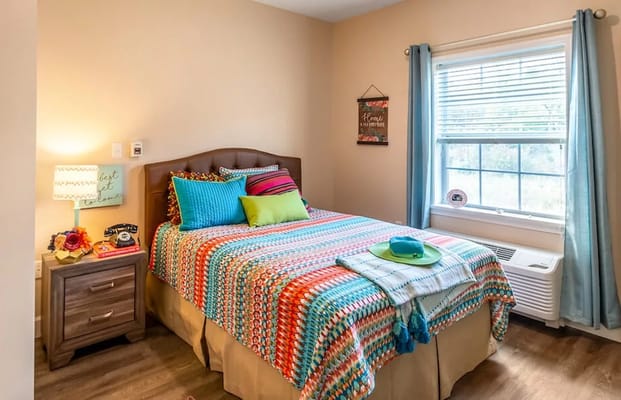 Cozy private resident room with colorful bedding