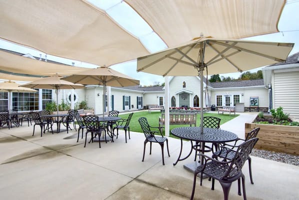 Outdoor seating area with tables and umbrellas