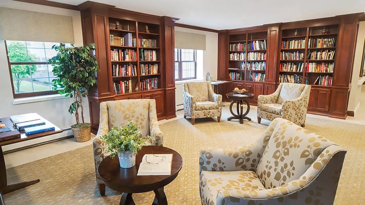 Bright common area with comfortable seating and bookshelves