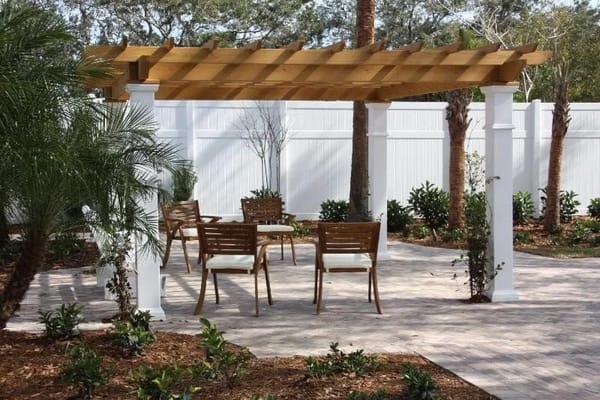 Outdoor seating area with pergola and plants
