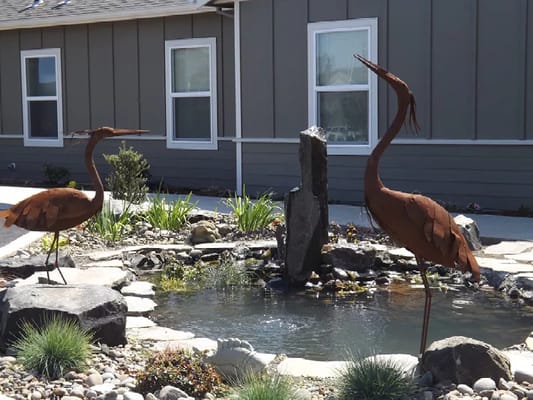 Outdoor garden feature with sculptures and water element