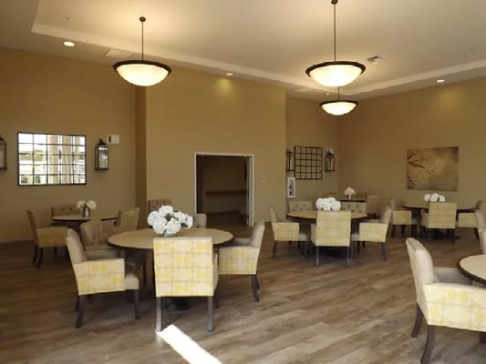 Bright common area with round tables and chairs